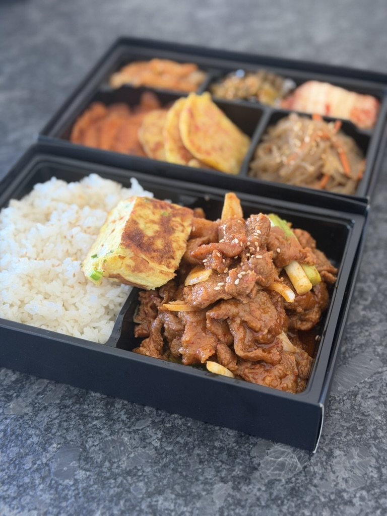 Spicy pork combo set: pork, rice and egg roll with a second tier of jeon and banchan